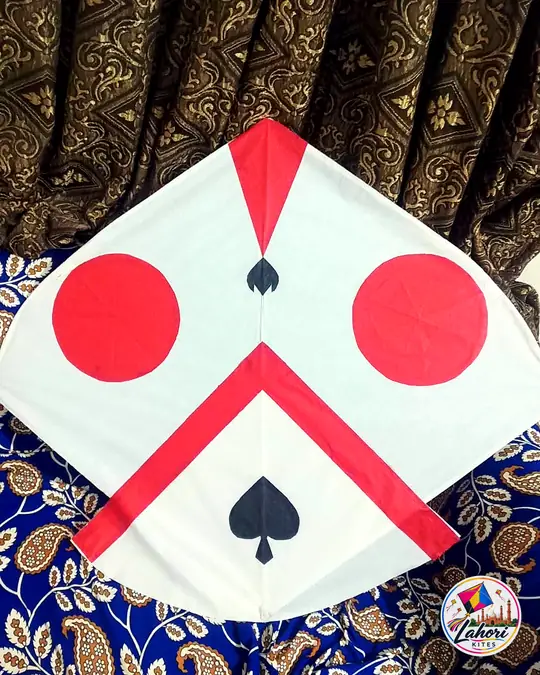 White kite with red circles and spades